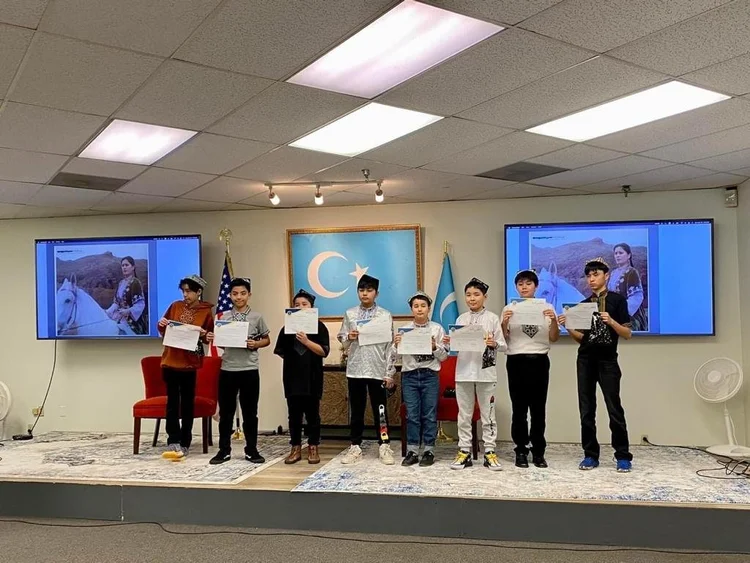 Students holding certificates on stage
